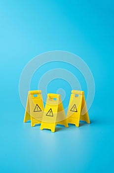 Warning yellow clamshell floor signs. Identify dangers and threats