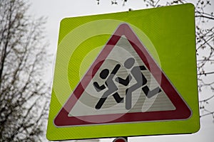 Warning yellow road sign school zone pedestrians closeup