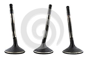 Warped three engine valves, covered with soot, isolated on a white background.