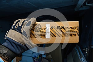 Warranty Void Sticker in Male Hand: Warehouse Scene