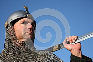 Warrior in chain mail, sword braced on shoulder