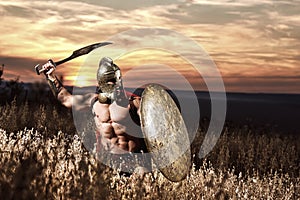 Warrior in helmet with bare torso going in attack.