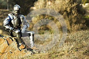 Warrior in metal armor decided to rest after the battle photo