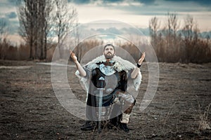 Warrior stood on one knee in the field.