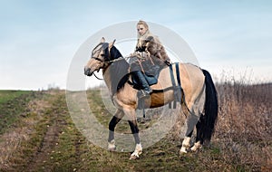 Warrior viking blonde female riding a horse - Medieval movie scene