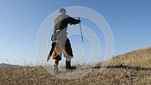 The warrior Viking sticking a swords into the ground