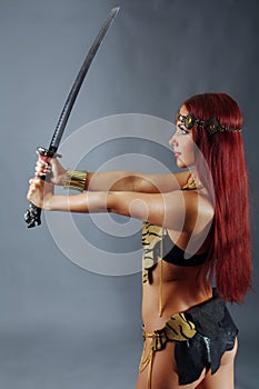 Warrior woman holding sword in her hand