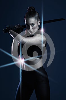 Warrior, woman and sword portrait to fight in studio for action on dark background. Strong female model, assassin or