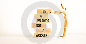 Warrior or worrier symbol. Concept words Be a warrior not a worrier on wooden blocks on a beautiful white table white background.