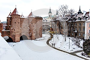 Warsaw Barbacan fortress castle in winter is in the capital city of Poland. Old town is the historic center of Warsaw