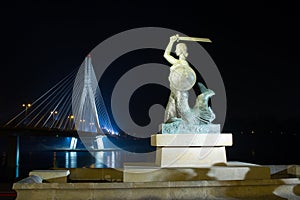 Warsaw by night mermaid on the Vistula river and bridge Swietokrzyski