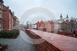 Warsaw, Poland Famous Barbican old town historic capital city during rainy winter day and red orange brick wall fortress