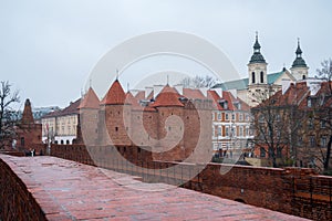 Warsaw, Poland Famous Barbican old town historic capital city during rainy winter day and red orange brick wall fortress