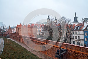 Warsaw, Poland Famous Barbican old town historic capital city during rainy winter day and red orange brick wall fortress