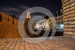 Warsaw, Poland Famous Barbican old town historic capital city and red orange brick wall fortress architecture at night