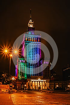 Warsaw,Poland-September 19,2021.View of illuminated colorful Palace of Culture and Science at night.Art deco high rise building