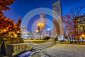 Warszawa, Poland - February 25, 2021: Amazing cityscape of Warsaw with metro station entrance by night, capital of Poland