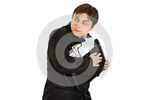 Wary businessman hugging briefcase with money