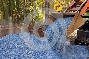 This was an excavator with a bobcat loader that was used to unload crushed stone during the road repair work on the site