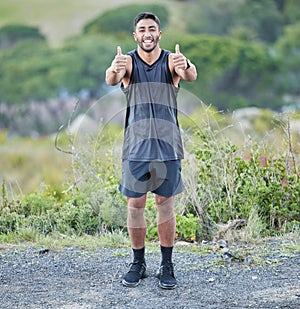 That was a good run. Full length shot of a handsome young man standing alone and showing a thumbs up after his outdoor