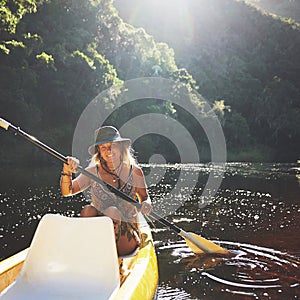 That was a good workout, mentally and physically. a young woman out kayaking on a lake.