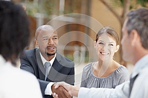 It was nice meeting you. Two businessmen shaking hands during a meeting.