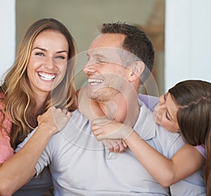 He was outnumbered. an affectionate family spending time together indoors.