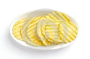 Wasabi and nori flavored salted ruffles, ruffled potato chips in white bowl