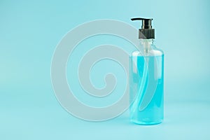 Wash hand sanitizer gel bottle on blue background, against Novel coronavirus or Corona Virus Disease Covid-19. Antiseptic,