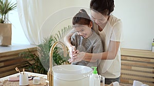 Wash hands routine procedure mum helps girl clean palms Spbd