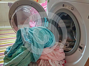 Wash machine and pile of wet clothes