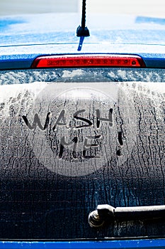 Wash Me Words on a Dirty Car Window photo
