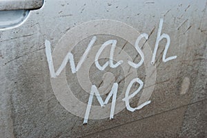 Wash me written on a dirty car