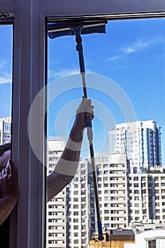 Wash panoramic windows against the blue sky, cleaning company