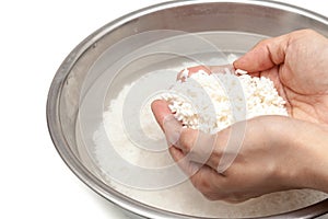Wash rice with water in the stainless bowl