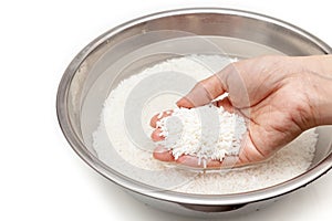 Wash rice with water in the stainless bowl