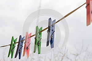 Wash things. clothesline. Clothes pegs. Drying things. Multi-colored clothespins. The photo is suitable for sites selling detergen