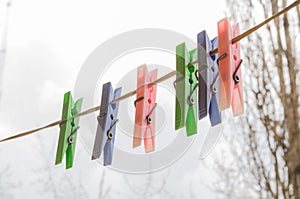 Wash things. clothesline. Clothes pegs. Drying things. Multi-colored clothespins. The photo is suitable for sites selling detergen