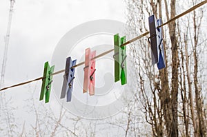 Wash things. clothesline. Clothes pegs. Drying things. Multi-colored clothespins. The photo is suitable for sites selling detergen