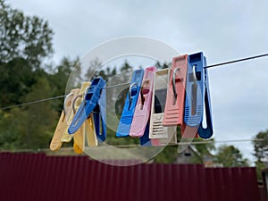 Wash things. clothesline. Clothes pegs. Drying things. Multi-colored clothespins. The photo is suitable for sites selling detergen