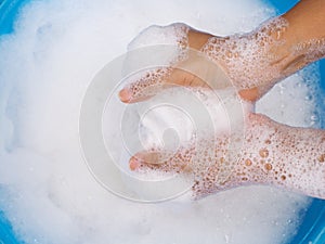 Wash white clothes and soak cloth in laundry detergent water in tub washing. photo