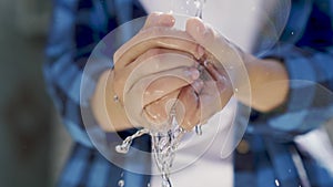 wash your hands with clean water, bokeh, wash germs with a clean transparent stream of water, save water sparingly in a