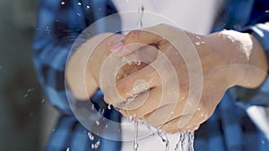 wash your hands with clean water, bokeh, wash germs with a clean transparent stream of water, save water sparingly in a