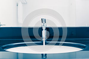 Washbasin with faucet and flowing water