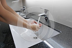 Washbasin and faucet on granite counter with hand washing