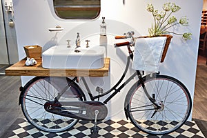 Washbasin and retro bicycle in bathroom