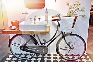 Washbasin and retro bicycle in bathroom