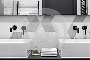 Elegant washbasins with black faucets