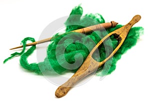 Washed Angora wool for felting or knitting. The distaff and spindle closeup on a white background.