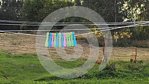 Washed clean laundry hanging on the rope or clothesline drying in the wind outdoors